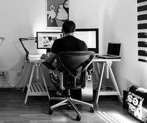 man sitting at home office desk