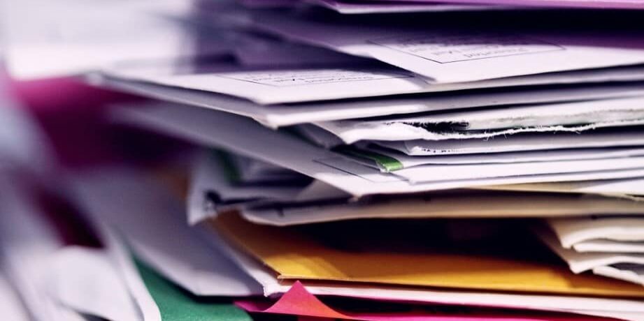 stack of papers before outsourcing mailroom